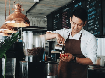 A barista preparing coffee with care